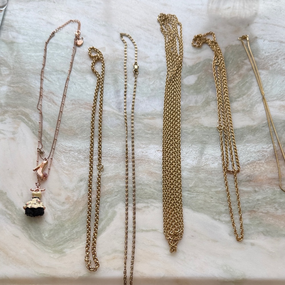 Gold chains and Betsey Johnson necklace. 7 total.